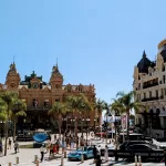 Busy square with luxury cars and architecture