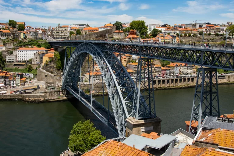 Grey metal bridge soars over the Douro River in Portugal