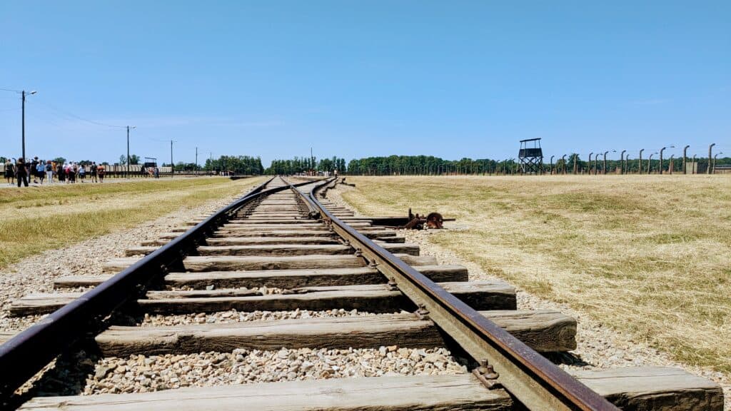 Railway tracks leading to a memorial.
