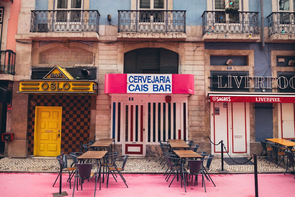 Vibrant urban scene featuring bar facades in Lisbon, showcasing colorful architecture.
