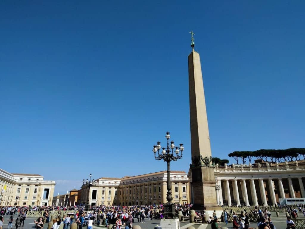 Iconic view of St. Peter's Square with the Egyptian obelisk and surrounding colonnades in Vatican City, showcasing a popular travel destination in Rome. The Vatican has to be on the best four day itinerary for Rome.